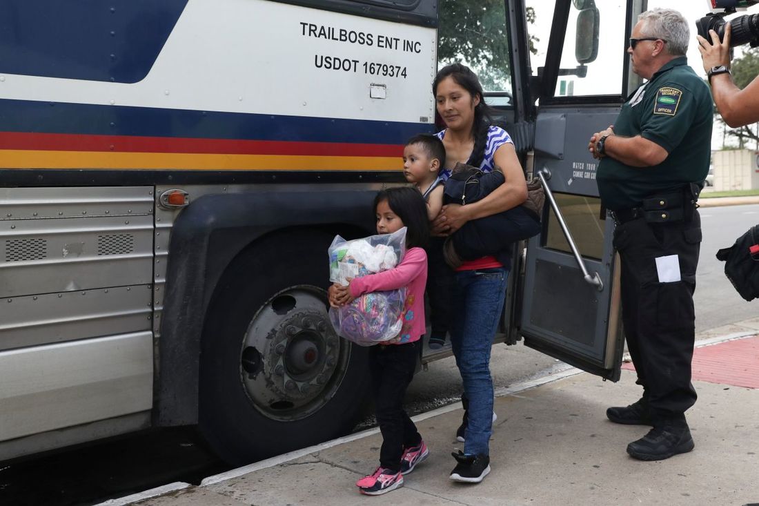 Migrant Mother and Her Children Exiting a Bus