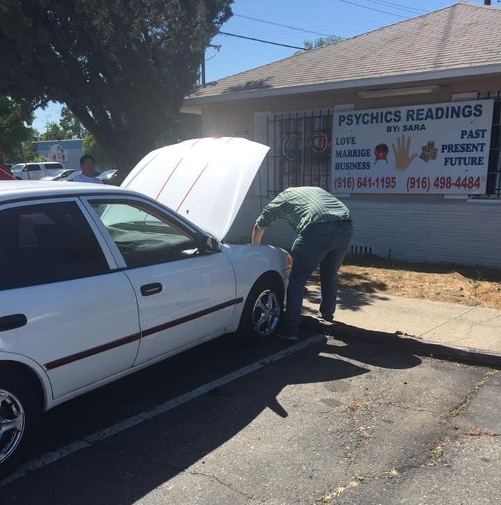 Volunteer Repairing a Car